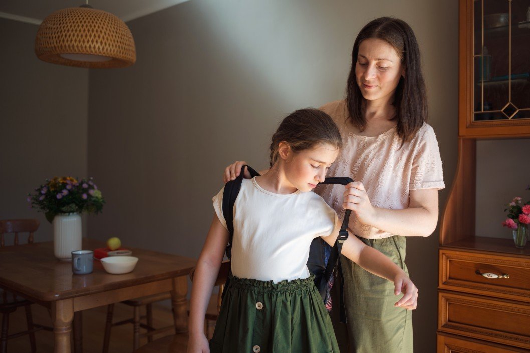 morning kitchen and dining room breakfast mom helps her daughter get ready for school she puts her t20 kLAnl4